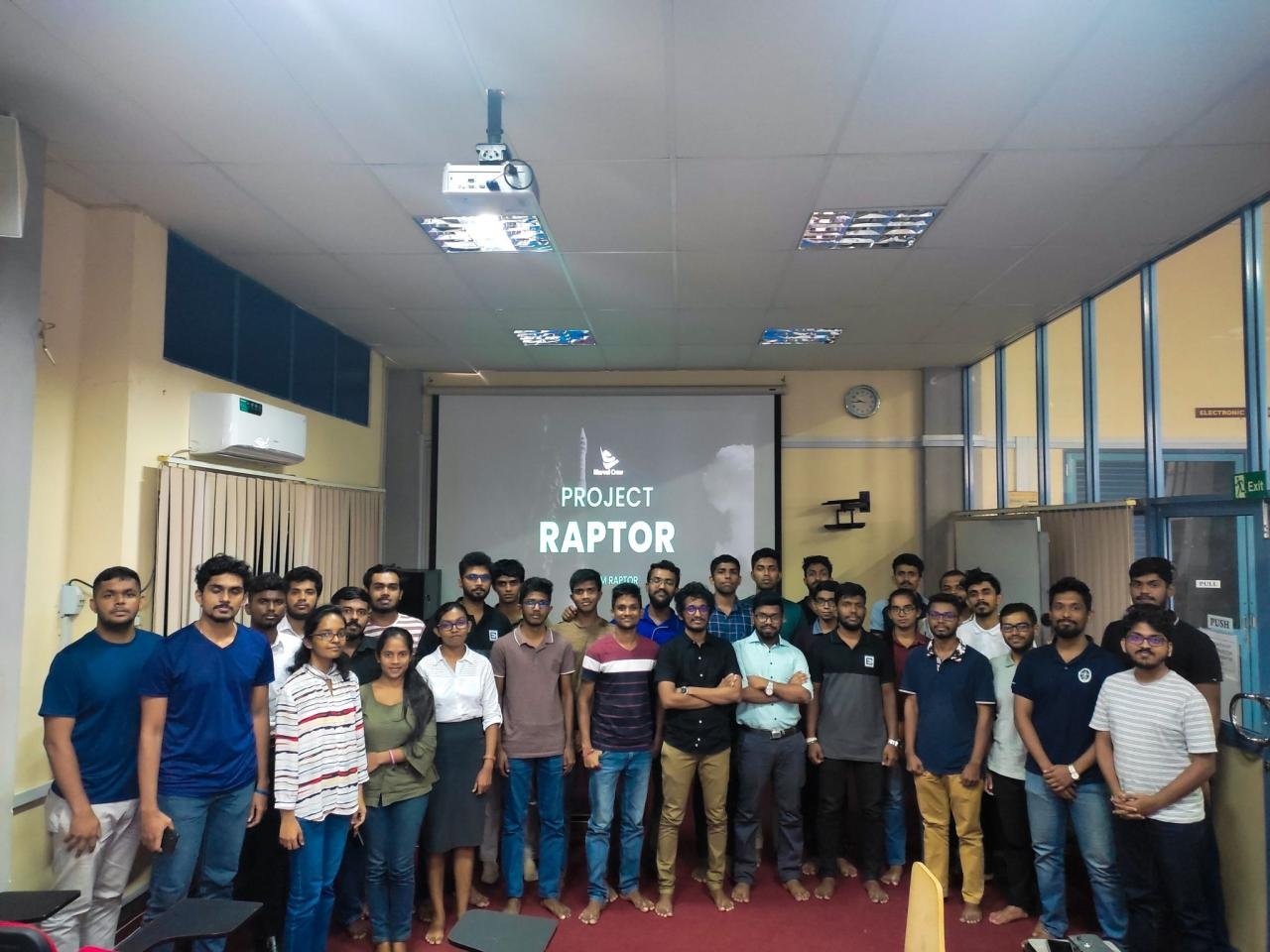 Wider Project Raptor team gathered in front of the project presentation